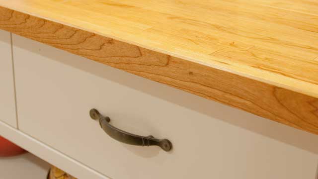 Closeup detail of new cherry butcherblock countertop installed on Ikea VÄRDE Base cabinet